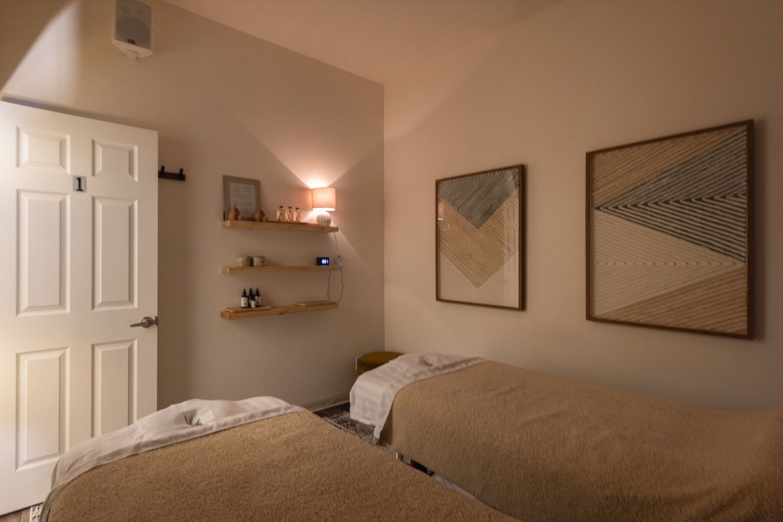 Couples treatment room at Butterfly Massage Spa — two massage tables with warm lamplight and soft linens